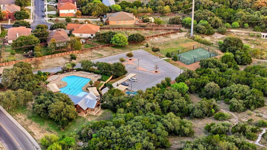 Aerial view of the community amenity center with pool, clubhouse and sports court