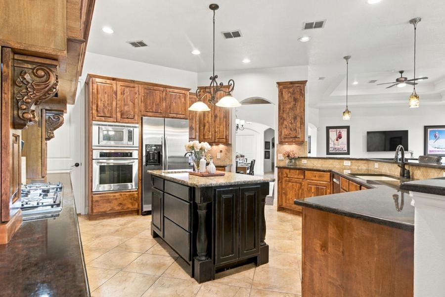 Kitchen with large island, bar seating and wood cabinetry