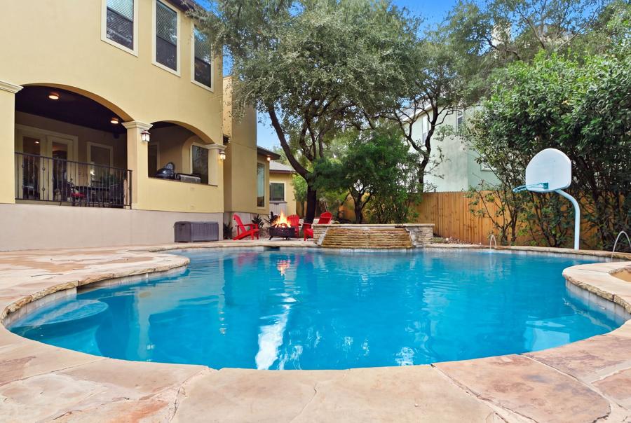 Pool and backyard with the rear of the home behind